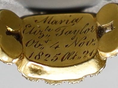 A George IV yellow metal and seed pearl set mourning ring(a.f.), with engraved inscription, 'Marion Eliz. Taylor, Obt. 4th Nov, 1825 at. 21', size O, gross weight 3 grams.